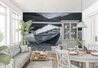 Monochrome mural wall mural with a rowing boat on a stony shore., GD9853