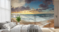 Serenity wall mural with sandy coast and rocky cliff for bedroom interior.