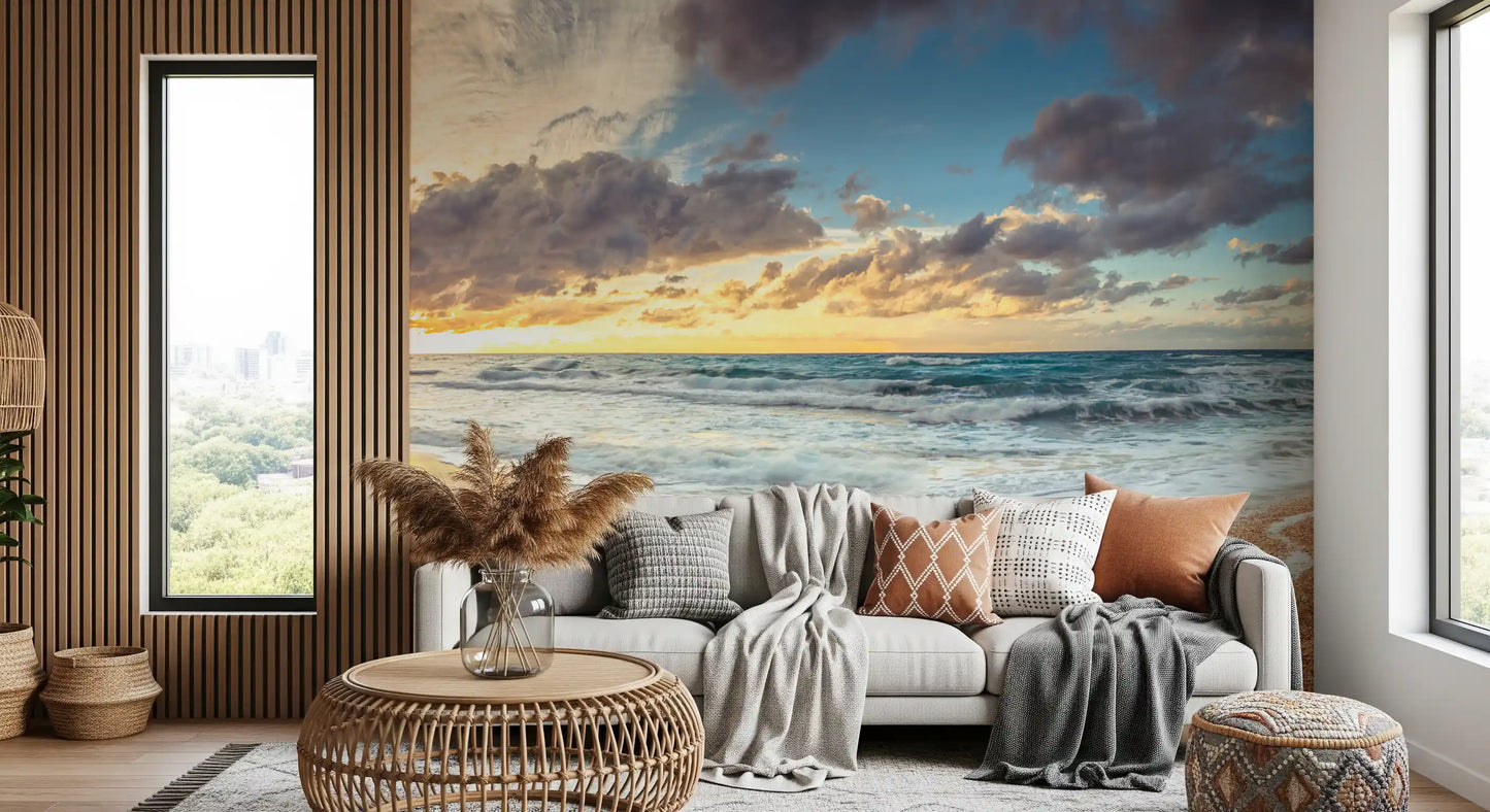Golden wall mural depicts sunset light over sea waves and pebbles.