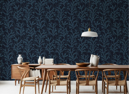 Painted branch motif wallpaper in deep blue colors for dining spaces.