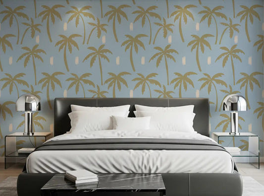 Muted gold palms sway across the bedroom in this boho coastal wallpaper.