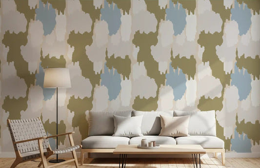 Living room walls hold a layered, painterly look with olive coastal wallpaper
