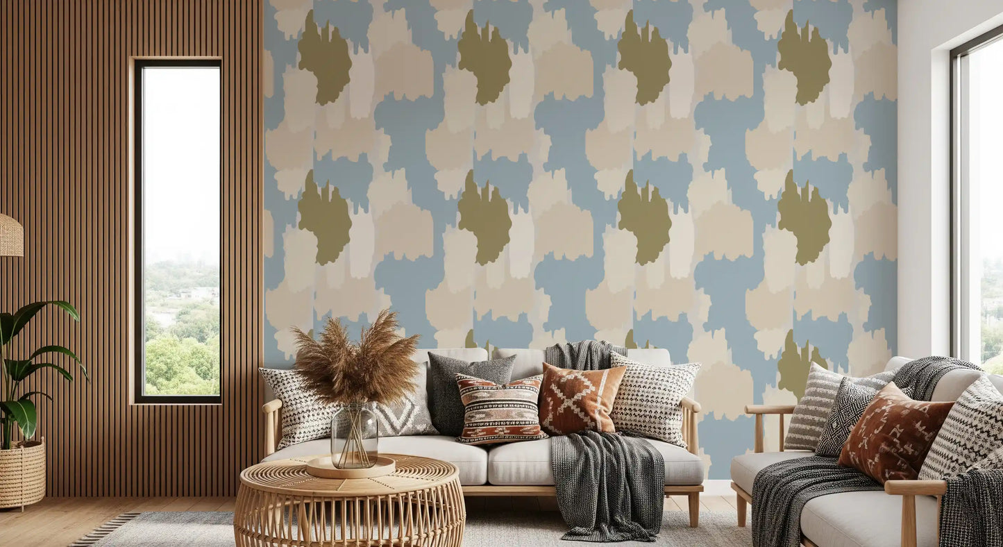 Painterly clouds float across this abstract coastal wallpaper in blue and sage.