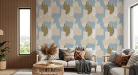 Painterly clouds float across this abstract coastal wallpaper in blue and sage.