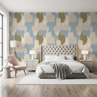 Quiet sage and blue cloud shapes drift through a bedroom in this boho coastal wallpaper.
