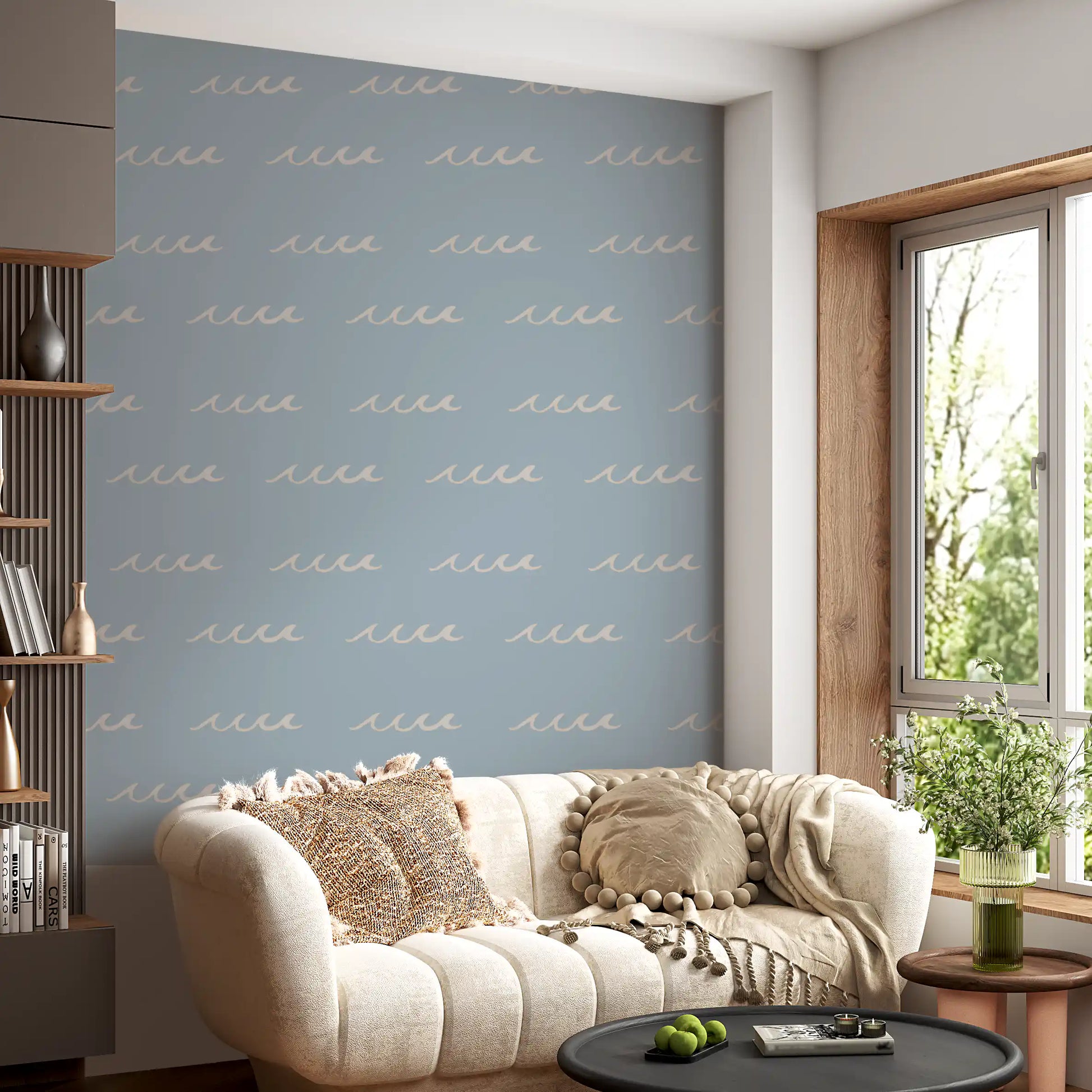 Lounge corner sits inside soft blue tones with boho wave wallpaper across the panel.
