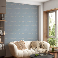 Lounge corner sits inside soft blue tones with boho wave wallpaper across the panel.
