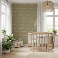 Hand-drawn crests scatter loosely on this olive green coastal wallpaper.