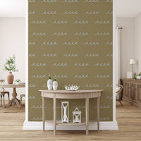 Warm olive ground holds sketchy waves in this boho coastal wallpaper.