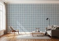 Boho Coastal Grid wallpaper as feature wall behind a gray sofa in airy contemporary living room., GD9913