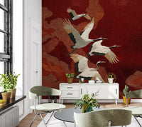 Four Japanese cranes fly across the Crimson Sky Crane Dance Wall Mural.