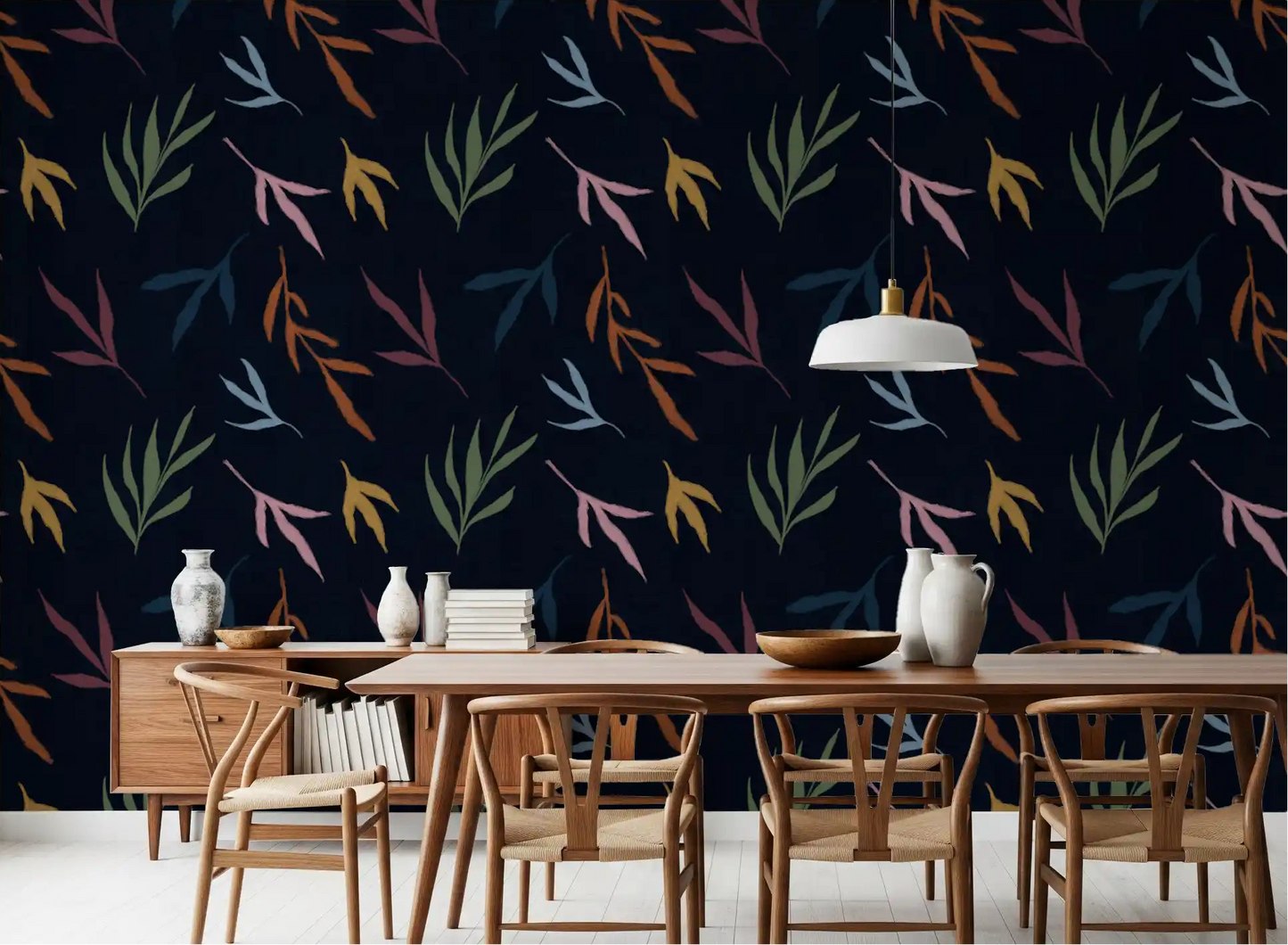 Deep navy wall with Tropical Painted Leaves wallpaper in dining room.