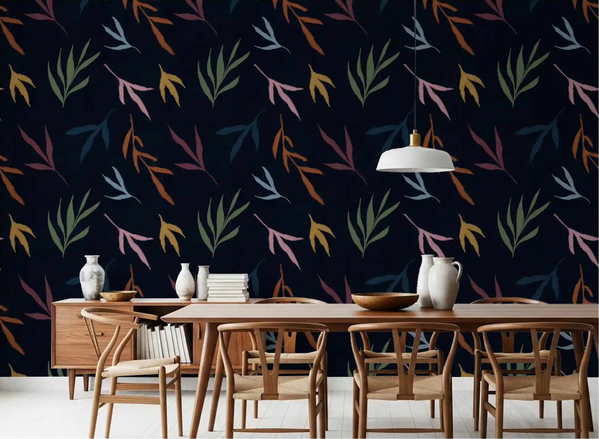 Deep navy wall with Tropical Painted Leaves wallpaper in dining room.