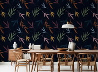 Deep navy wall with Tropical Painted Leaves wallpaper in dining room.