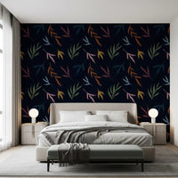 Sunlit bedroom wall featuring this moody tropical leaf wallpaper.