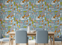 Dusty blue veggie mid century wallpaper creates a fun vibe in a dining room.