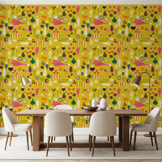 A bright mustard vegetable wallpaper lines the walls of a sunlit dining room.