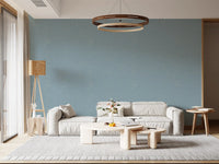 Dusty blue linen wallpaper creates a relaxing backdrop in a large living room.