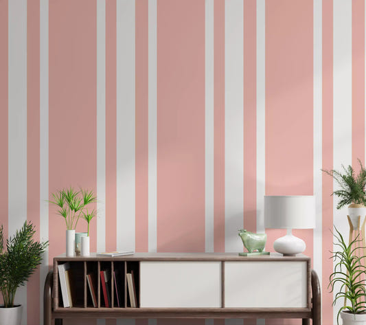 A classic pink ticking wallpaper lines the welcoming hallway walls.