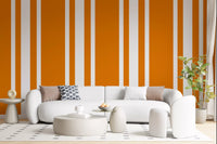 Bright orange retro wallpaper lines a modern hallway.