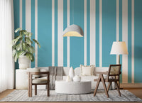 A sunlit living area displays mid century blue ticking stripe wallpaper.