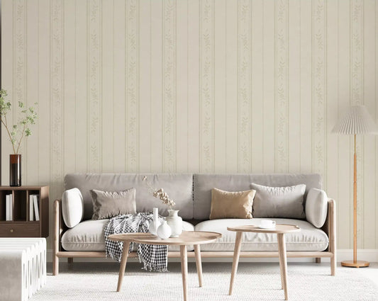 Living room wall covered in cream ivory floral stripe wallpaper beside a white cot and rug.