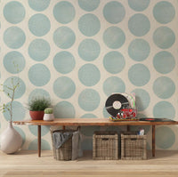 Large organic polka dots wallpaper with stippled texture in soft blue for hallway.