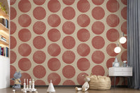 Kids playroom wallpaper showing organic circular dots in warm rust tones 