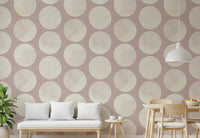 Living room accent wallpaper with geometric circles in cream and dusty rose.
