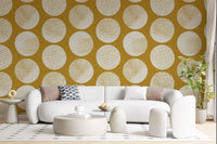 Warm mustard wallpaper featuring cream polka dots with sophisticated stippled gold detail.