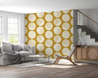 Contemporary polka dot pattern in cream and gold stipples on mustard geometric wallpaper.