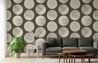 Large cream dots featuring random speckle marks arranged on brown wallpaper.