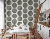 Removable slate grey polka dot wallpaper for dining room on cream base.