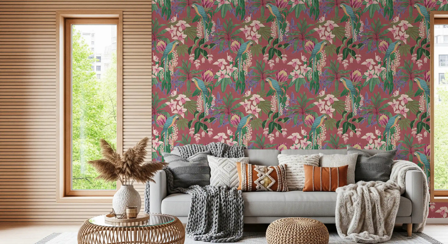 Pink orchid and protea flower pattern wallpaper with teal macaw parrots in living room.