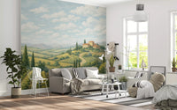 Pastoral landscape mural with cypress trees and distant mountain range in living room.