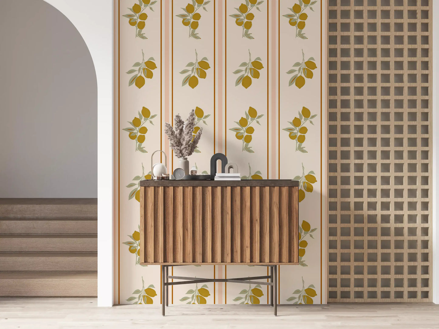 Golden lemons and pale sage leaves arranged in two branch clusters on cream wallpaper with thin rust stripes.