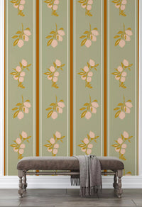 Sage lemon branch wallpaper with cream fruit and ochre leaves in hallway.