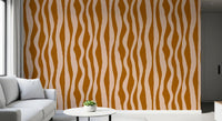Living area wall decorated with organic wave pattern wallpaper in earthy boho tones.
