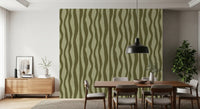 Olive green wavy stripe wallpaper styled on a dining room feature wall 