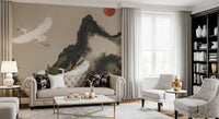 Ink wash mountain mural with white cranes, red sun and soft cream-toned sky.