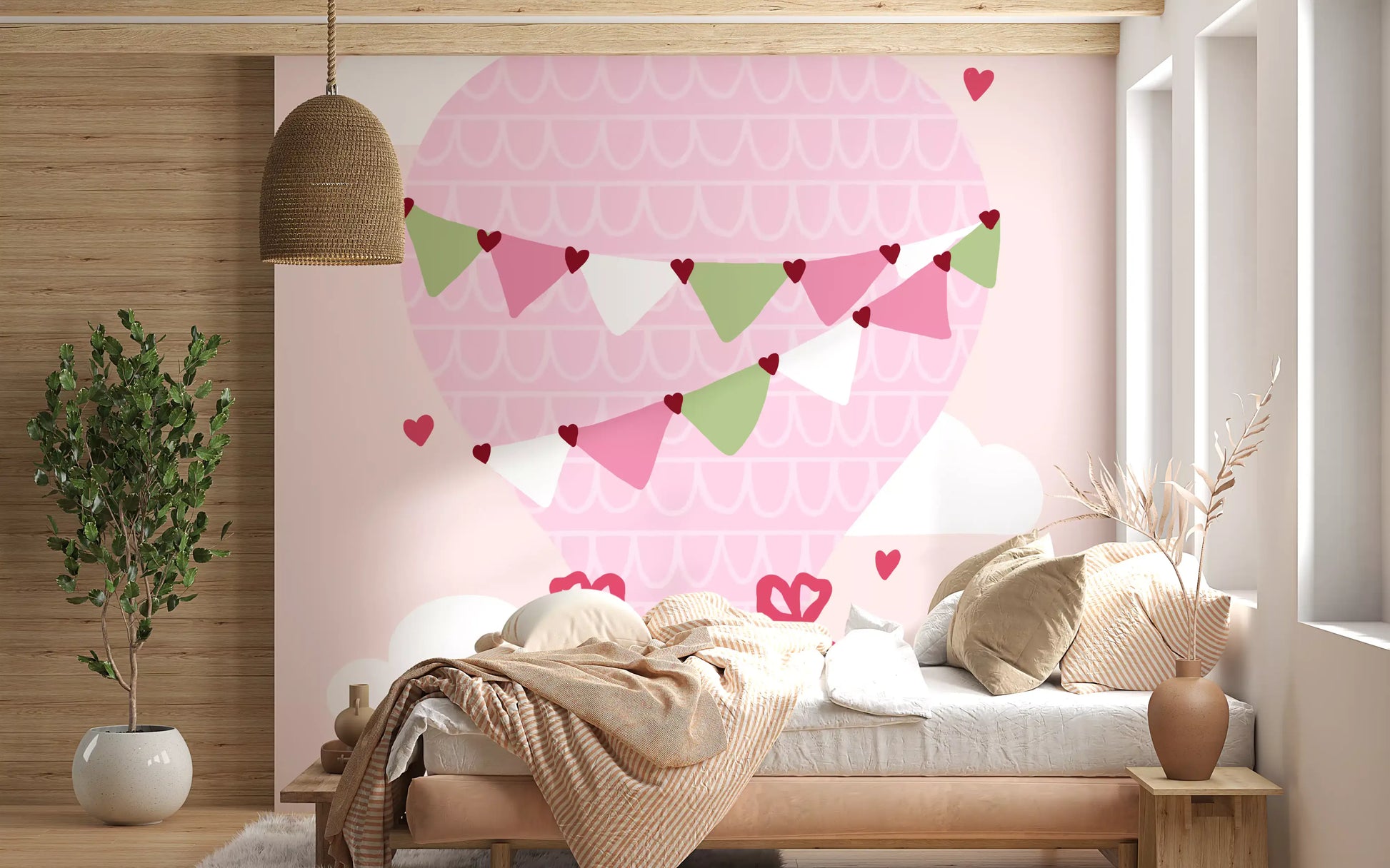 Pastel pink kids wall mural with floating heart accents in bedroom.