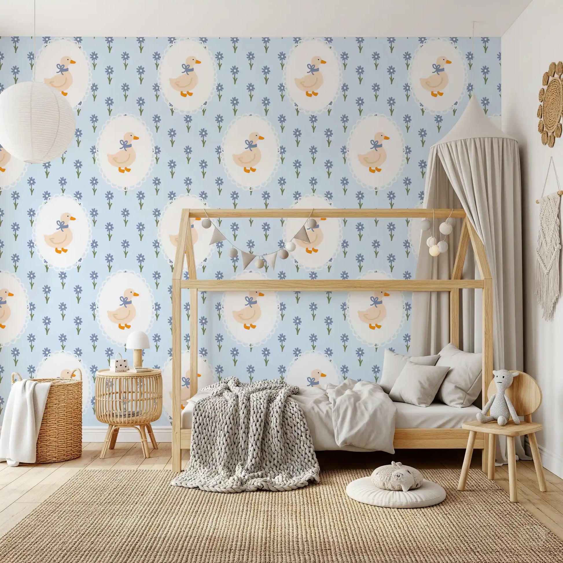 Daisy and goose wallpaper across a toddler bedroom wall.
