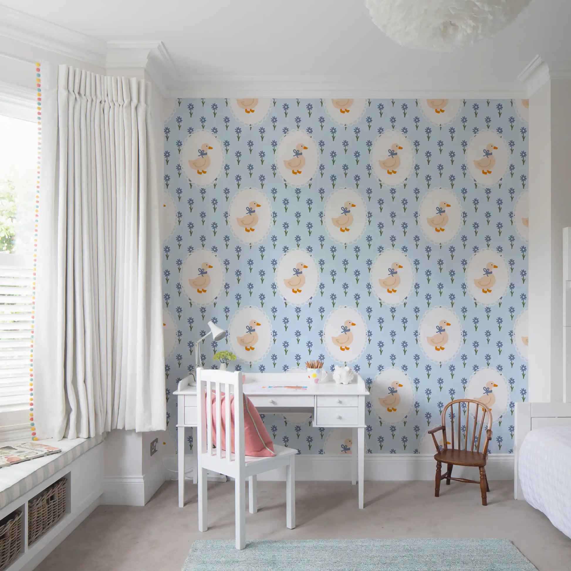 Soft blue floral wallpaper featuring goose motif in a study room.