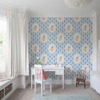 Soft blue floral wallpaper featuring goose motif in a study room.