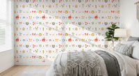 Children friendly pattern wallpaper with embroidery hoop and vases of blooms.