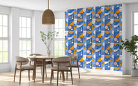 Dining room feature wall styled with Bauhaus geometric wallpaper in pink and cobalt tones.
