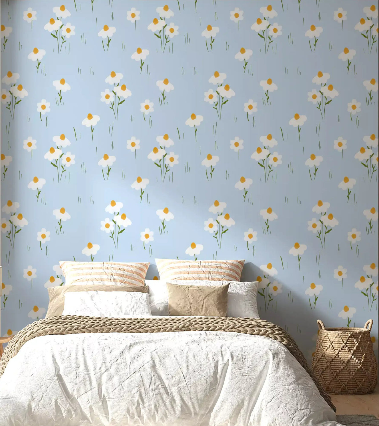 Bedroom wall with daisy wallpaper in soft blue and white tones.