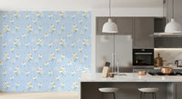 Kitchen area backdrop with pale blue daisy floral wallpaper.
