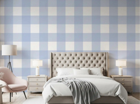 Blue checkered wallpaper styled on a bedroom accent wall.