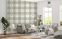 Living room wall with sage green gingham floral wallpaper in soft check and scattered wildflower pattern 